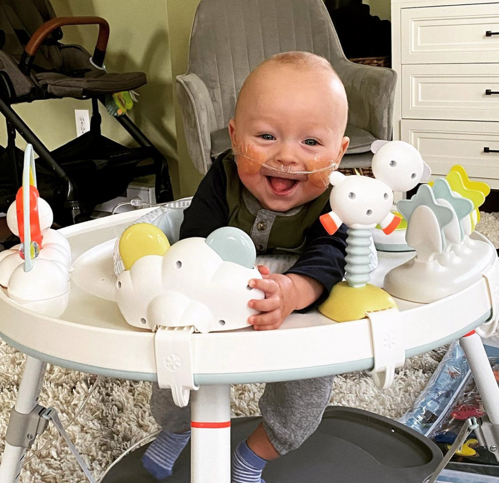 Baby Holden holding a toy.