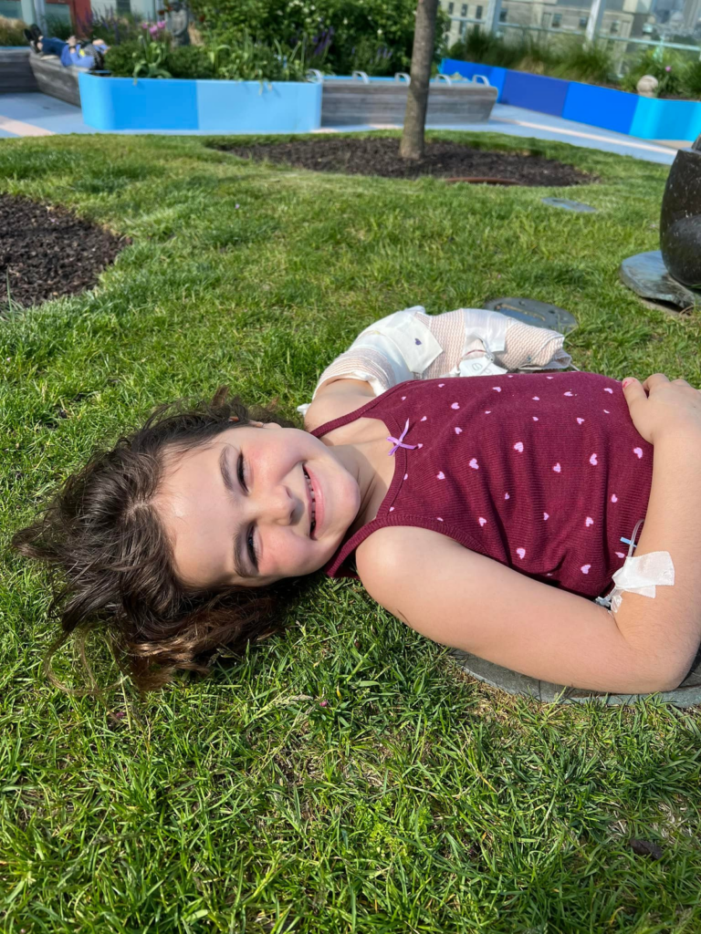 Violet, smiling in the grass.