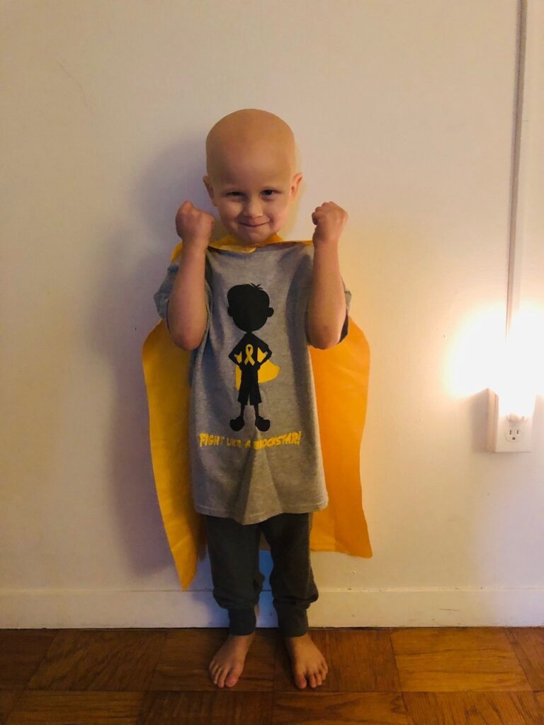 A smiling Brock with his fist balled and smiling.