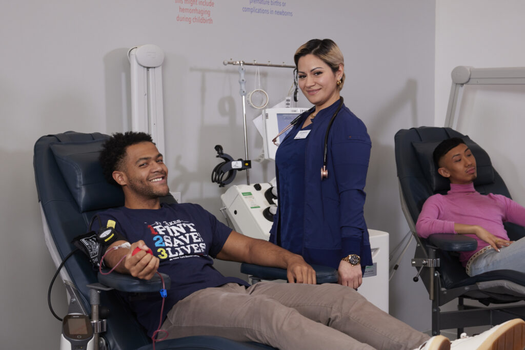 Rhode Island Blood Center phlebotomist with donor reclining in donation chair