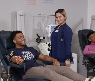 Rhode Island Blood Center phlebotomist with donor reclining in donation chair