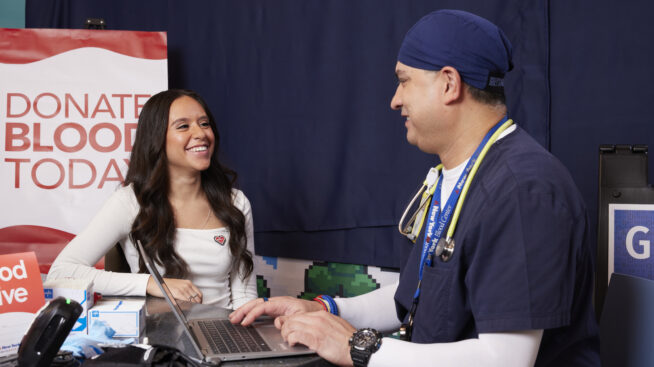 RIBC donor intake specialist taking information from a blood donor at RIBC donation center
